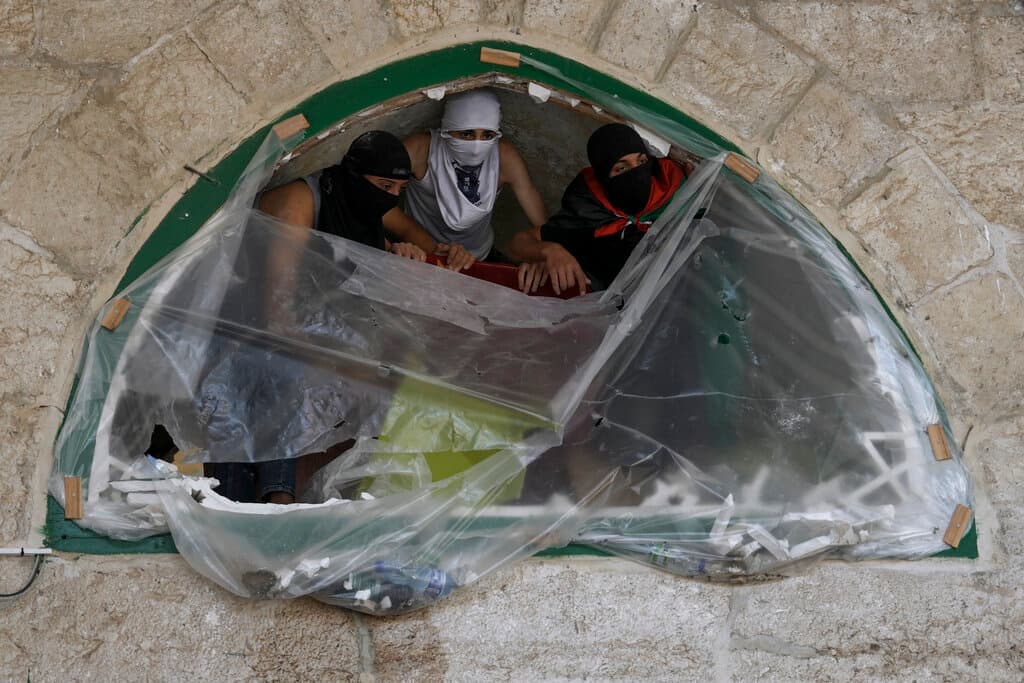 Videos que circulaban en internet mostraban a palestinos arrojando piedras y fuegos artificiales, mientras los agentes respondían con gases lacrimógenos y granadas de aturdimiento en la amplia explanada que rodea al templo. En otras grabaciones podía verse a los fieles atrincherándose en el interior de la mezquita.