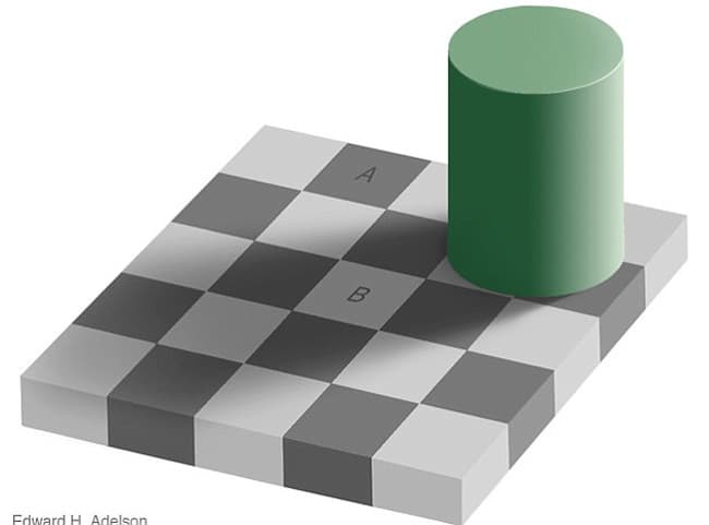 Es una de las ilusiones más famosas. El cuadrado A y el B son del mismo tono de gris. Sí, lo son, lo puedes comprobar 
<a href="http://web.mit.edu/persci/people/adelson/checkershadow_proof.html">aquí</a>.