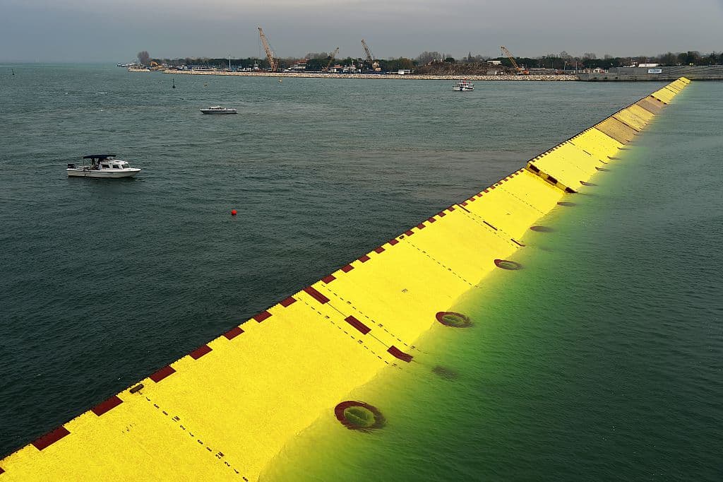 Blocks of the mobile gates of the Experimental Electromechanical Module (Mose), a project intended to protect Venice from floods, emerge during technical tests at the "Bocca di Porto" at Venice's Lido, on November 28, 2014. The Mose is a defence system with rows of mobile gates installed at the Lido, Malamocco and Chioggia that will be able to isolate Venice's lagoon from the Adriatic sea when tide reaches above about a meter. AFP PHOTO / VINCENZO PINTO (Photo credit should read VINCENZO PINTO/AFP/Getty Images)