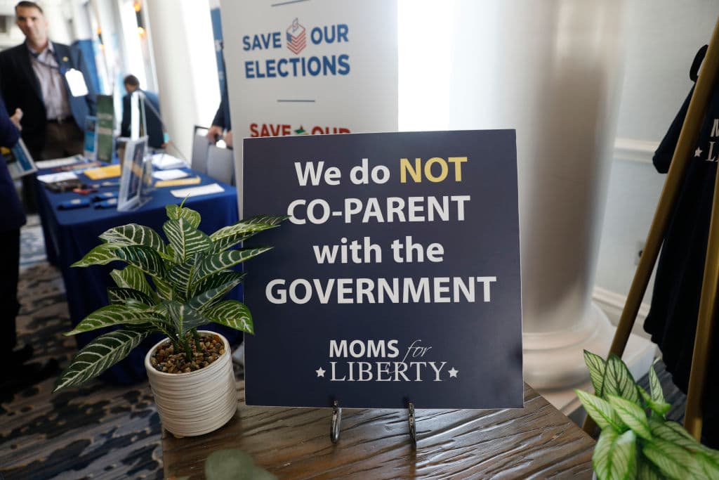 Un cartel con el lema de la organización "No compartimos la paternidad con el gobierno", en el lobby del lugar en donde se realizó la primera cumbre del grupo, en julio de 2022.