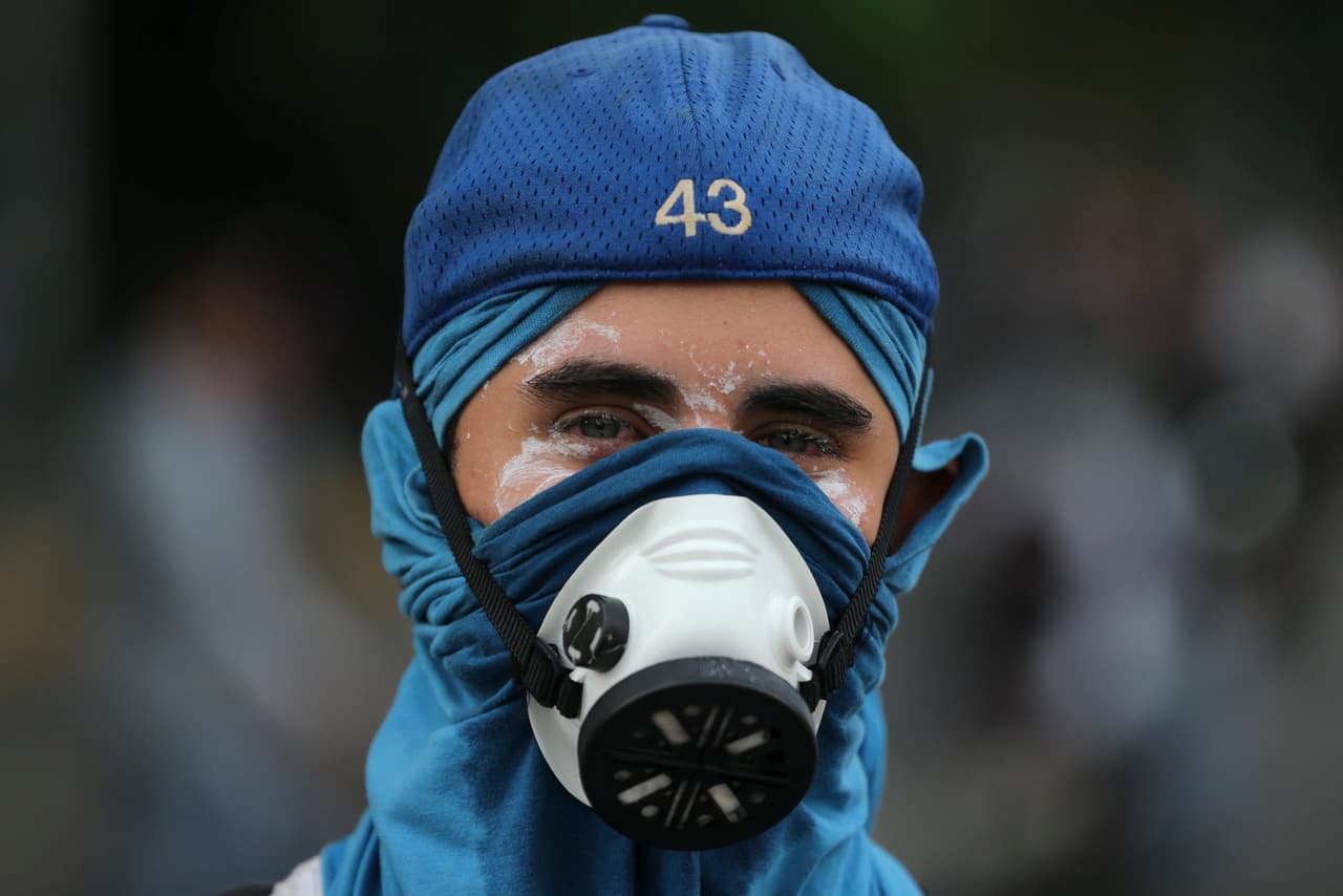 The eyes are protected by Maalox antacid solution and the neck and head with a tightly wrapped cloth which also covers the mouth and nose under an industrial quality gas mask.