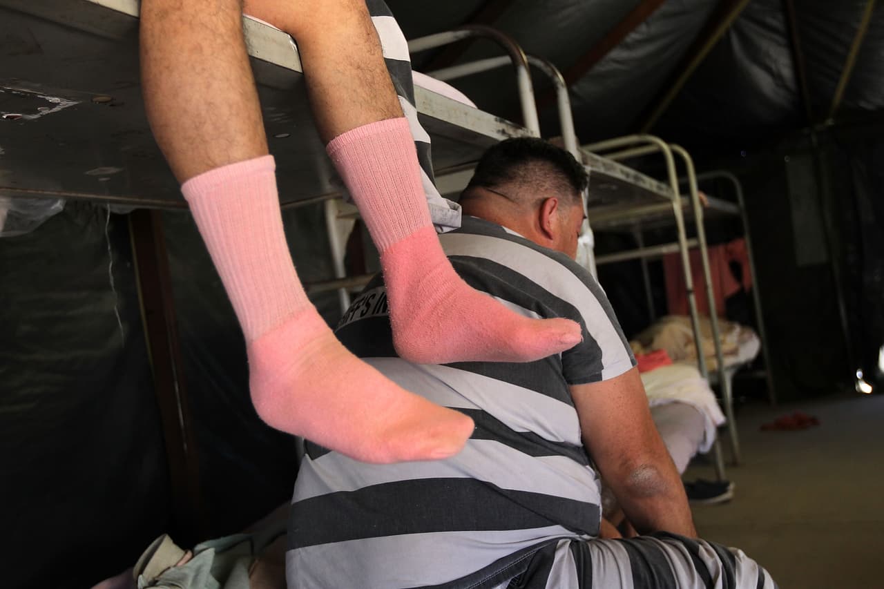 A priosoner shows off his pink socks.