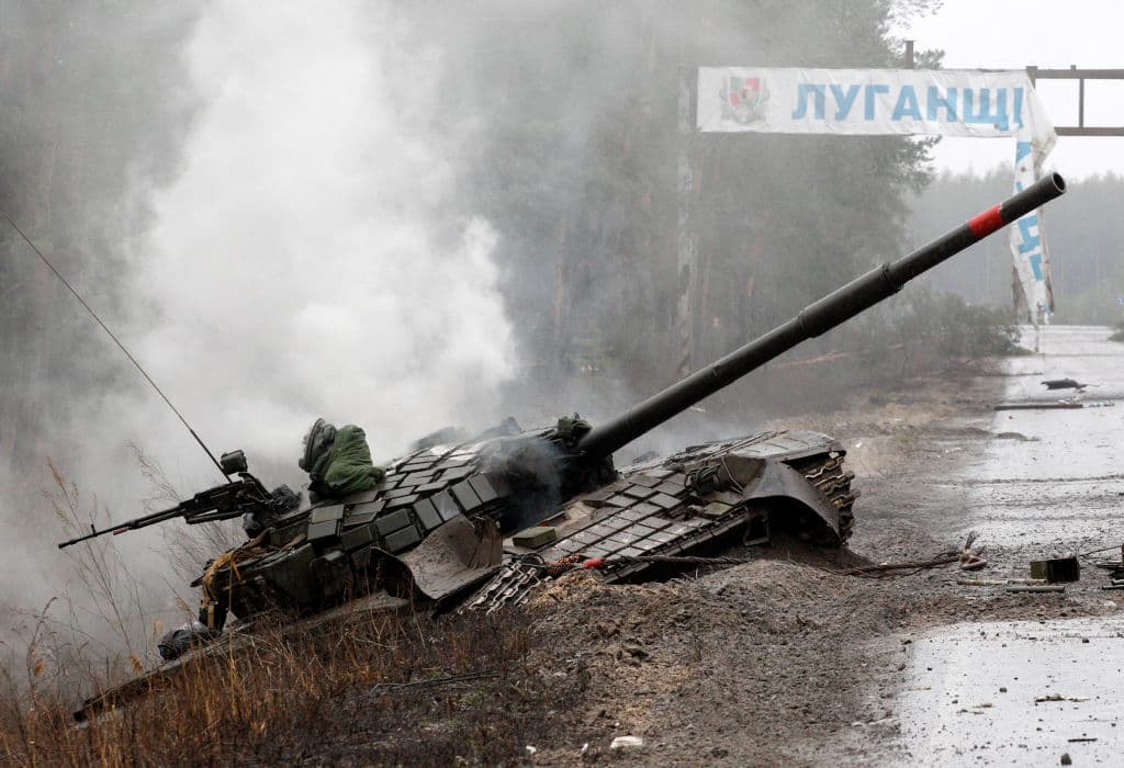 Smoke rises from a Russian tank destroyed by the Ukrainian forces on the side of a road in Lugansk region on February 26, 2022.