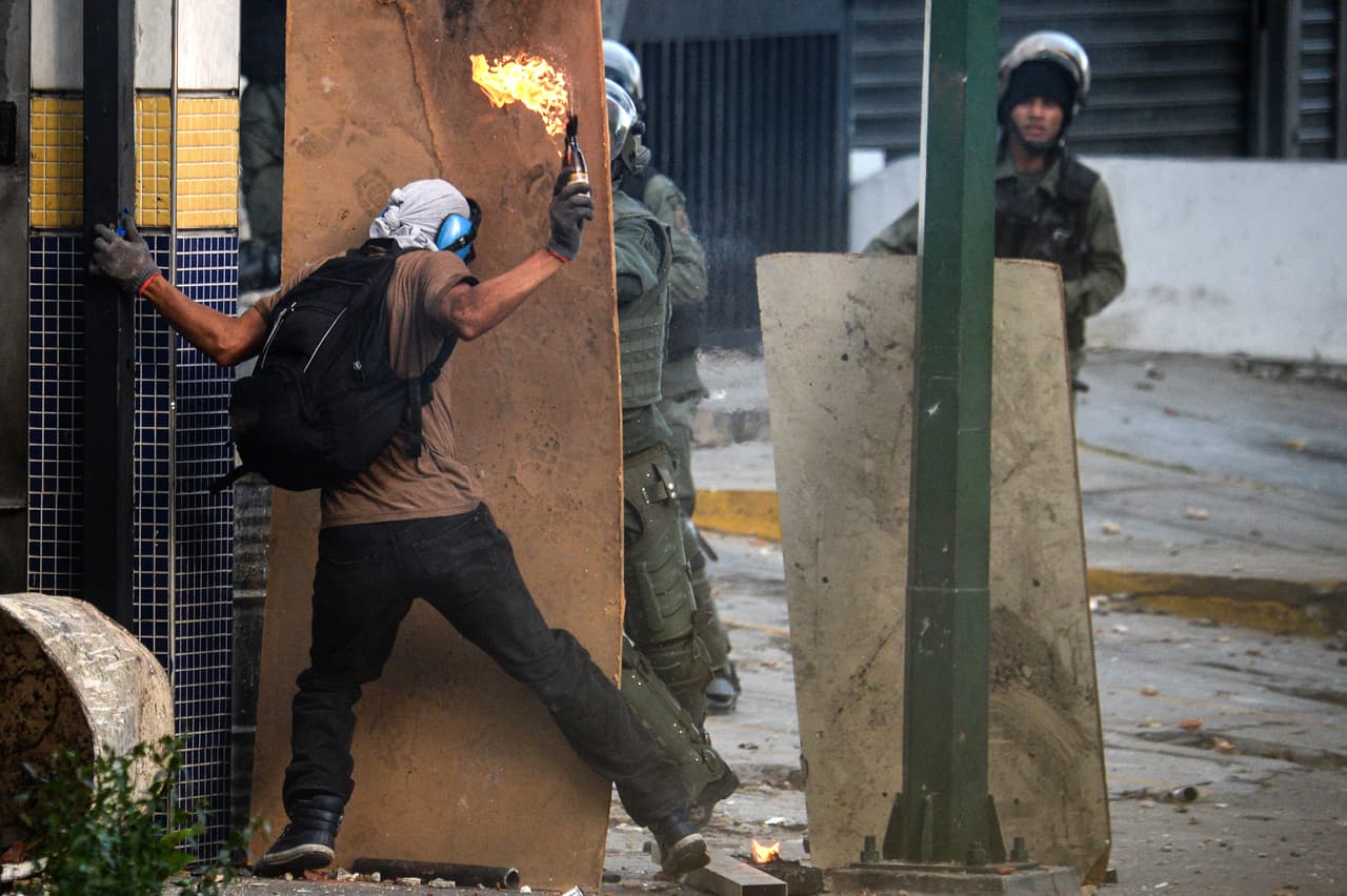 Un manifestante opositor ataca a la fuerza pública non una bomba molotov.