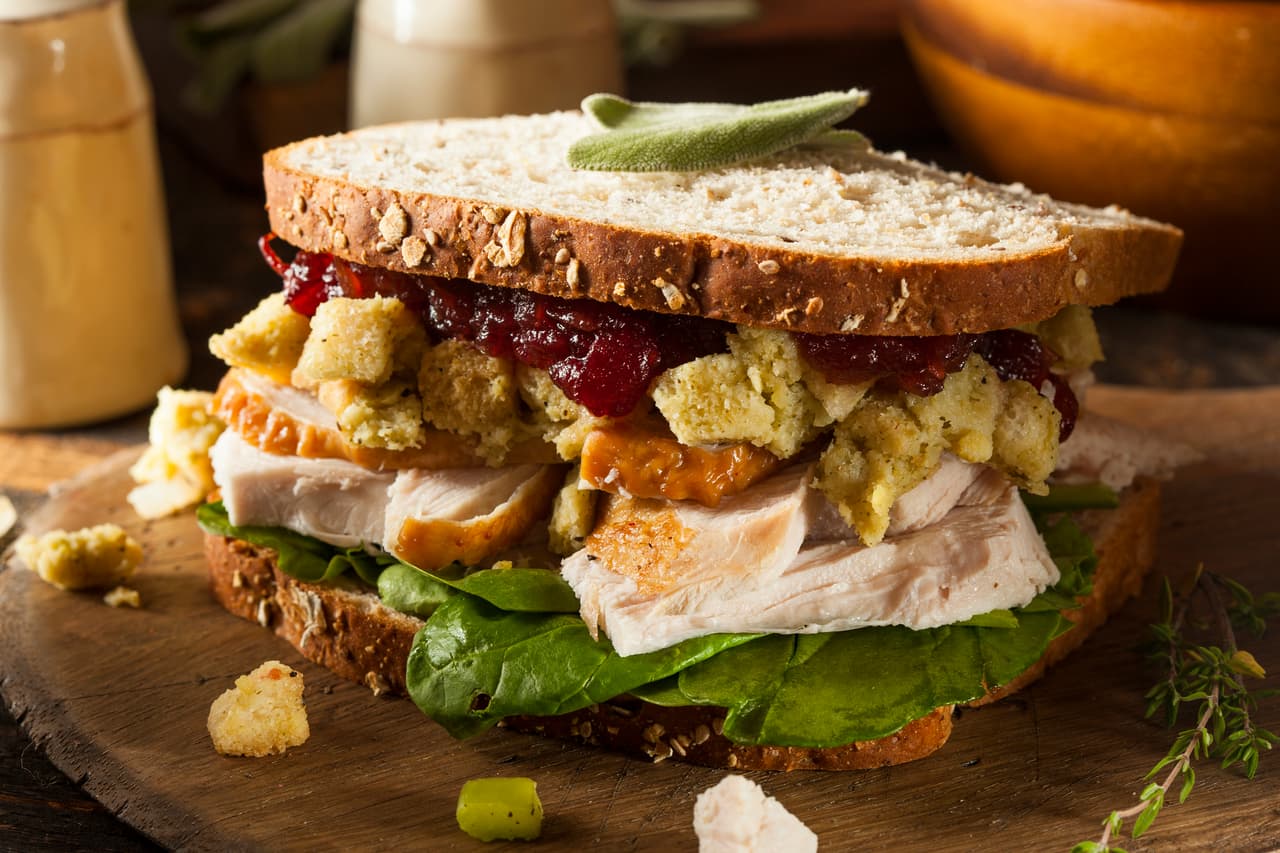 <b>Sándwich turco:</b> un pan integral relleno de pavo, acompañado de mayonesa y rodajas de lechuga y salsa de arándano. 
<br>