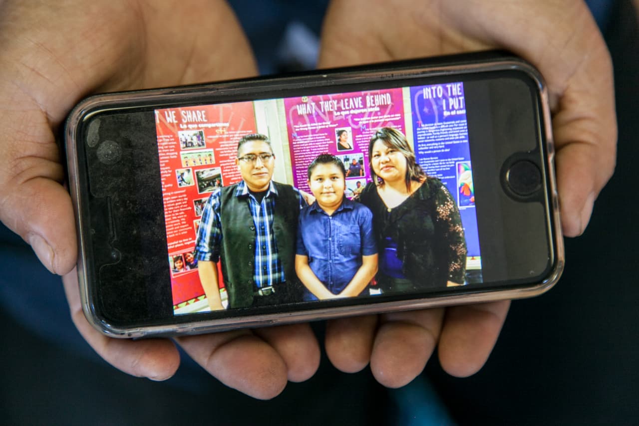 Maty came to the U.S. in 2003. She was the youngest of 12 siblings and wanted to seek better economic opportunities and help her family. Her husband, Victor Chavez, who is now 40, arrived years before, in the early 1990s, fleeing from the violence of the war in Guatemala. The army had killed Victor's father and other relatives. In the photo, Maty shows a photo of her with her husband Victor and son Jimmy.