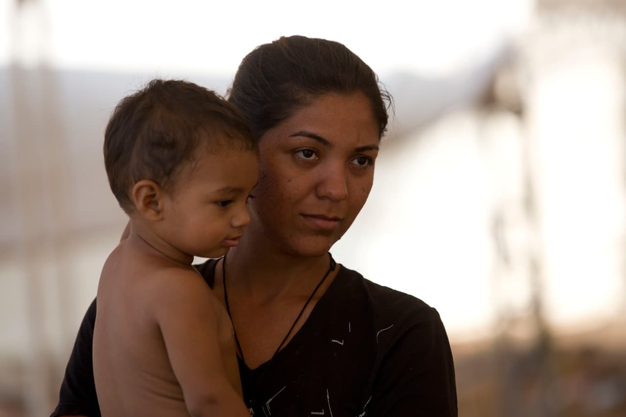 La migrante hondureña Ainee Villanueva con su hijo Iker en un campamento en Mapastepec, estado de Chiapas, México, este sábado 20 de abril. 
<b>Ellos son parte de la nueva caravana que espera llegar a la frontera con Estados Unidos. Según la agencia AP, Villanueva ha estado por 25 días esperando los documentos que la autorizan a cruzar a México. </b>