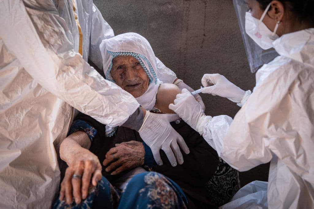 En la imagen, la enfermera Bilge Koç inyecta a una anciana de 99 años con la vacuna china en la remota villa de Daldere, en el oriente turco.