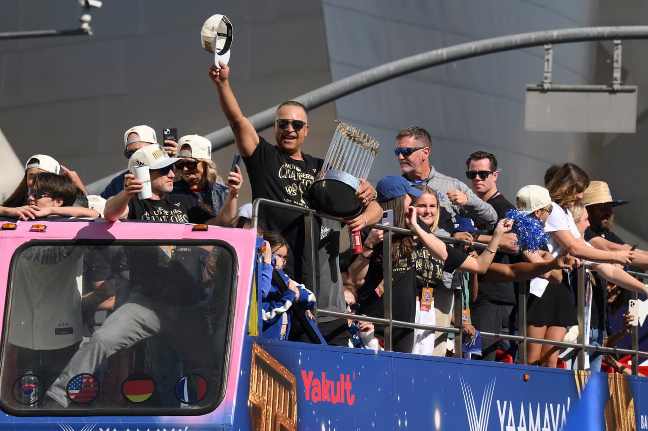 El mánager de Los Ángeles Dodgers, Dave Roberts, saludó a los fanáticos con su gorra en alto durante la celebración del desfile.