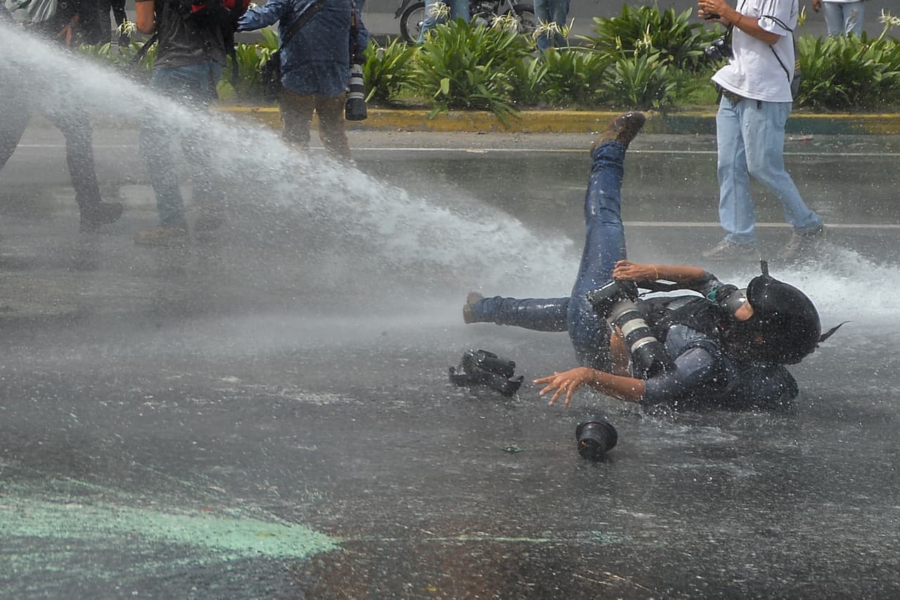 El chorro de agua de un vehículo de control de disturbios fue disparado directamente contra Ariana Cubillos, fotógrafa de la agencia AP en Caracas. 22 de mayo de 2017.