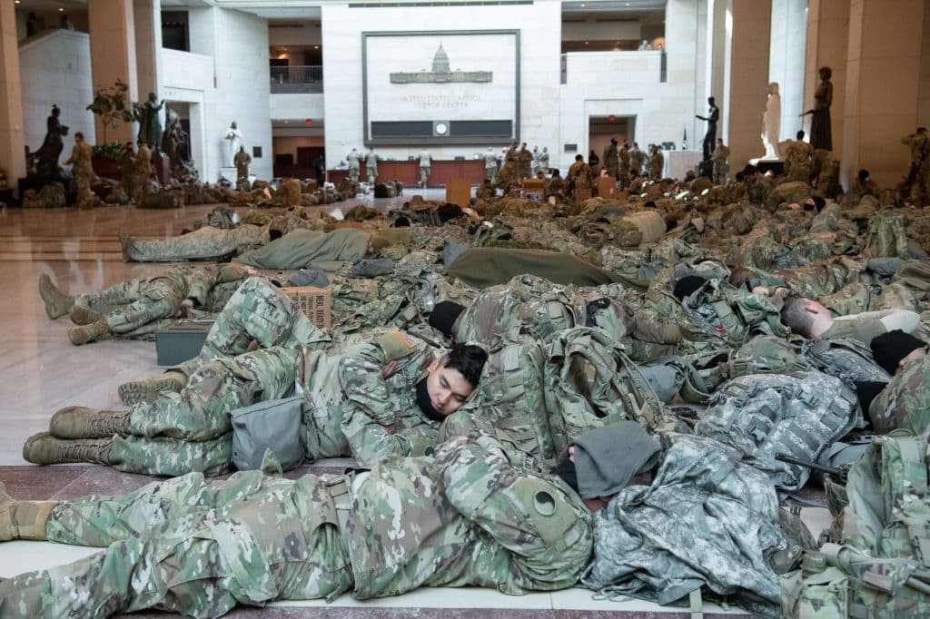 Members of the National Guard rest in the Capitol Visitors Center on Capitol Hill in Washington, DC, January 13, 2021. National Guardsmen were given authorization to be armed in support of the U.S. Capitol Police to protect the Capitol and individual members of Congress and their staff, according to a National Guard Bureau media release. This was requested by federal authorities and authorized by the secretary of the Army.