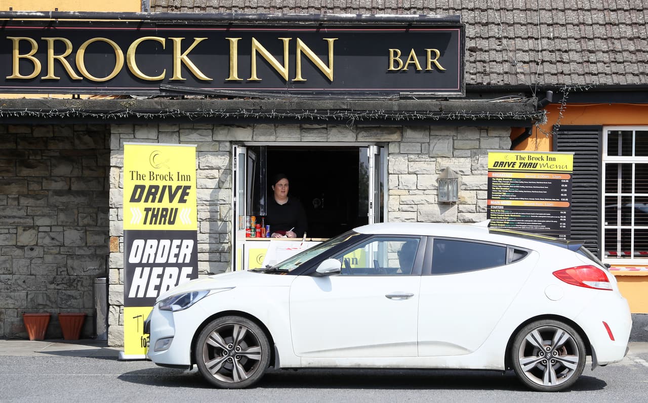 <b>Restaurantes sin contacto.</b> Un empleada de un restaurante en Dublín, Irlanda, toma las órdenes de los comensales que llegan a auto al establecimiento. Desde el inicio de las regulaciones muchos restaurantes en todo el mundo han atendido a sus clientes con servicios para llevar. 25 de abril.
<br>