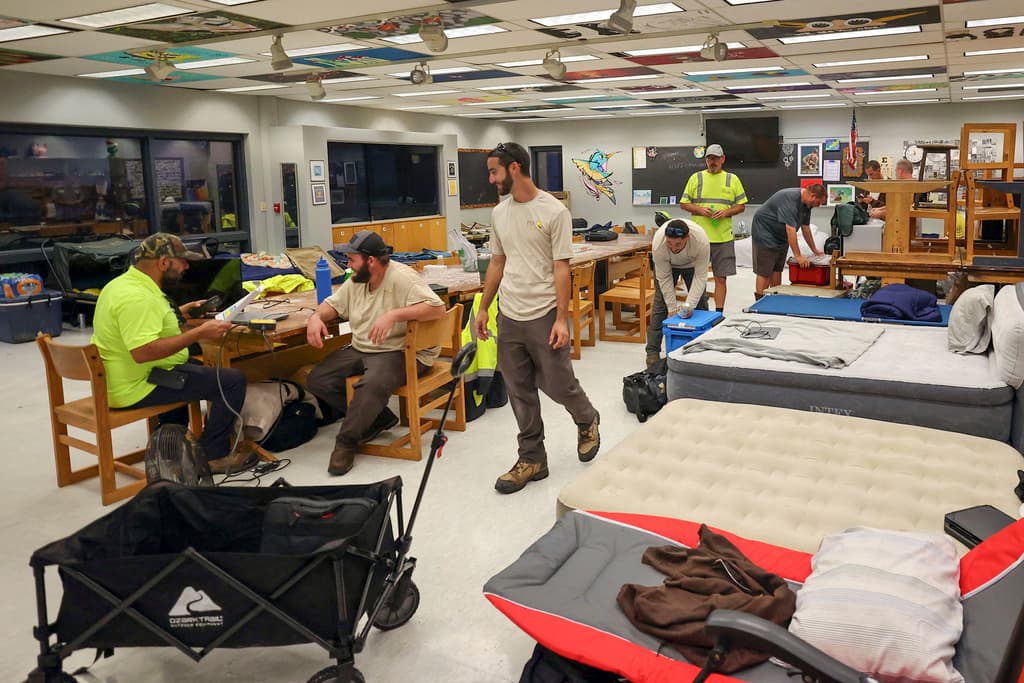 <b>Listos para responder:</b> Miembros de los servicios públicos del condado de Pasco se instalaron en las aulas de un refugio contra huracanes en la escuela secundaria River Ridge, mientras pasa el huracán Milton, el miércoles 9 de octubre de 2024, en New Port Richey, Florida.