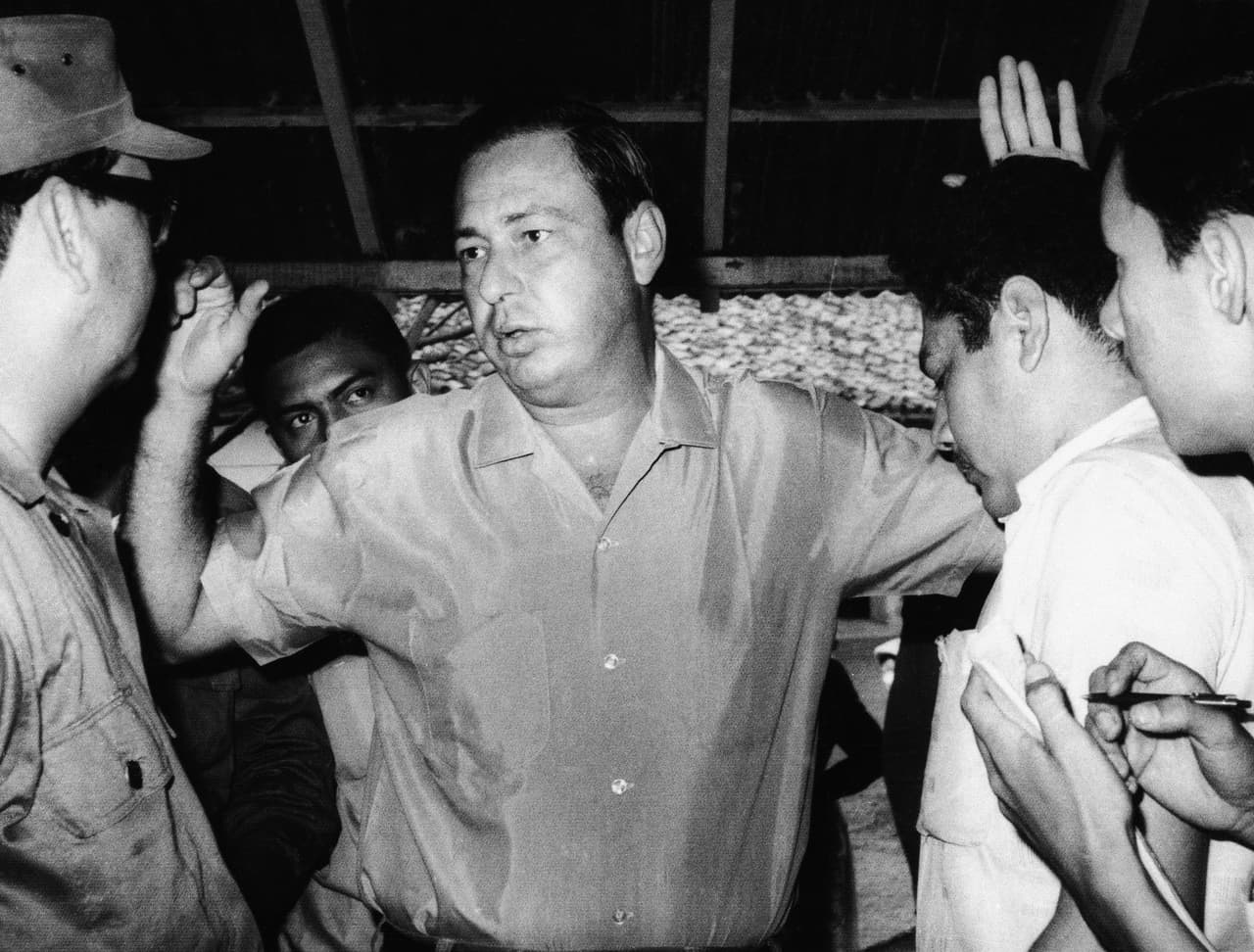 Pedro Joaquin Chamorro, publisher of La Prensa, Nicaragua's largest newspaper, holds up his hands as he talks to newsmen after his arrest in Managua, Jan. 26, 1967. In 1978, he was assassinated by an unknown gunman, supposedly on the orders of dictator Anastasio Somoza. His death helped spark the Nicaraguan revolution which toppled Somoza in July 1979.