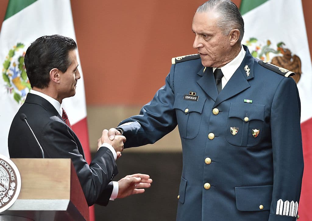 En esta gráfica del 8 de enero de 2016, el presidente mexicano Enrique Peña Nieto felicita al secretario de Defensa, Salvador Cienfuegos, por la recaptura del fugitivo capo del Cartel de Sinaloa, Joaquín 'El Chapo' Guzmán.