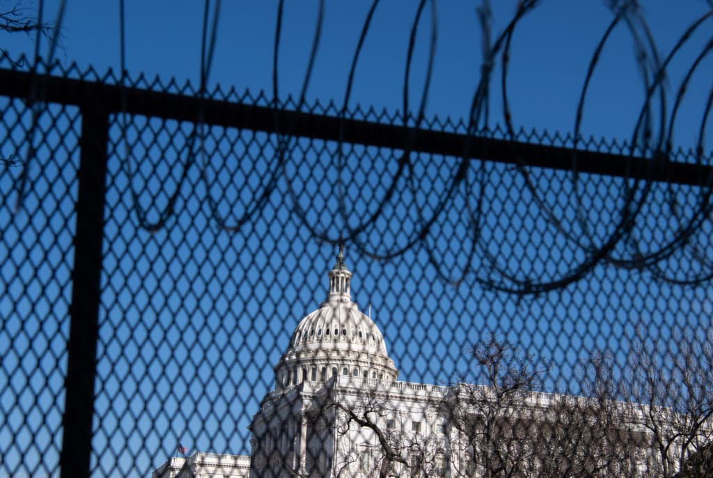 Barbed wire is installed on the top of a security fence surrounding the US Capitol in Washington, DC, January 14, 2021, ahead of the presidential inauguration of Joe Biden.