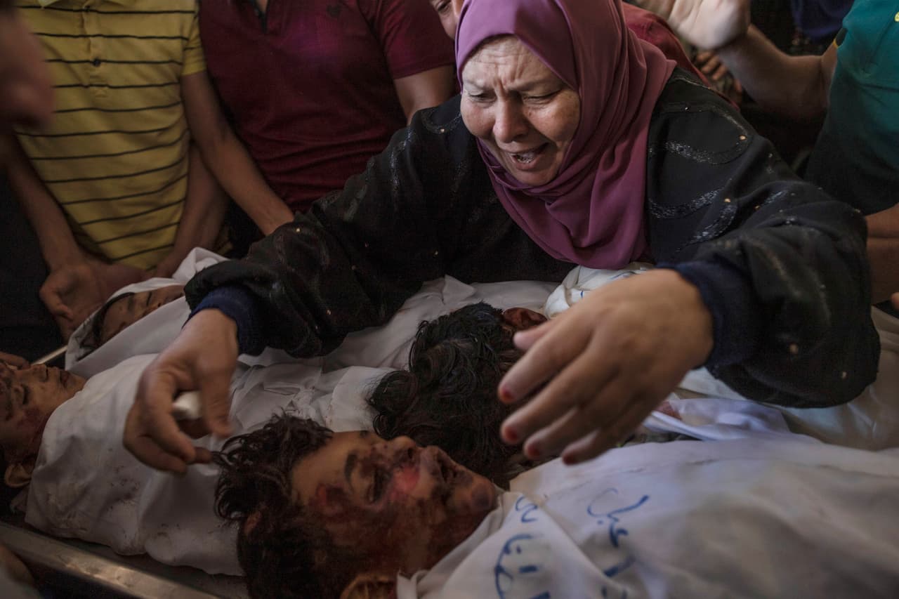 Hamas comenzó a lanzar cohetes hacia distintas zonas del territorio de Israel como parte de la represalias, e Israel respondió con bombardeos aéreos y desplegó tanques y aviones de combate. En la foto una mujer palestina junto a los cuerpos de cuatro hermanos de la familia Tanani que fueron encontrados bajo los escombros de una casa destruida al norte de la Franja de Gaza, el 14 de mayo.