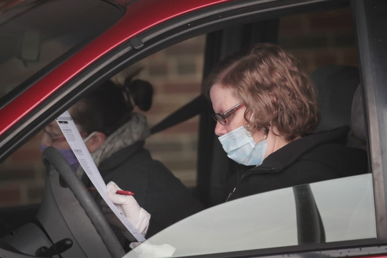 Una votante sufragando desde su auto en una escuela de Racine, Wisconsin, en un centro de votación adaptado para votar con seguridad a pesar del coronavirus. La Corte Suprema de Wisconsin restableció las elecciones cinco horas después de que el gobernador demócrata Tony Evers las suspendiera debido a la pandemia.