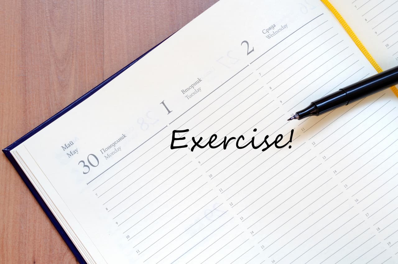 Yellow blank notepad on office wooden table exercise concept