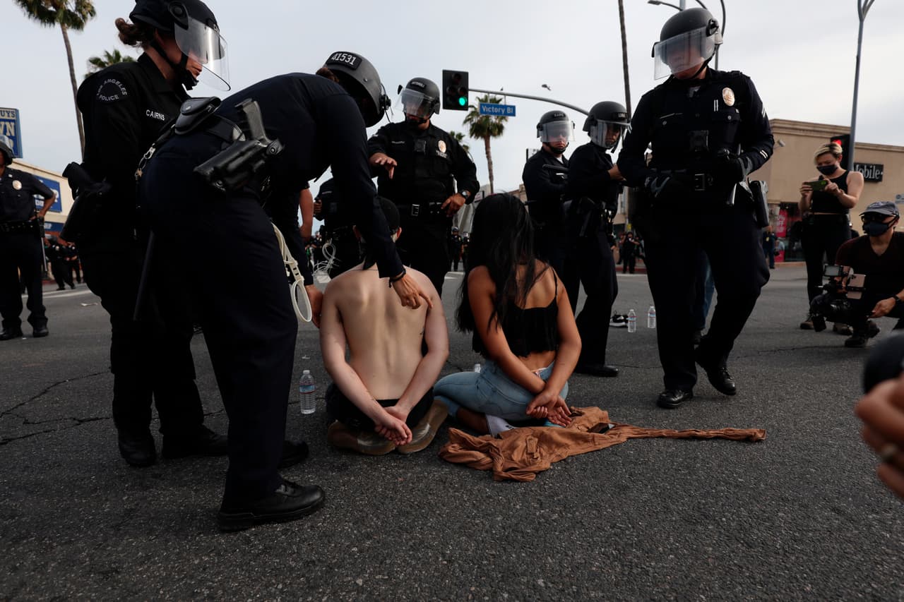 Al menos 5,600 personas han sido arrestadas en diversas ciudades de Estados Unidos desde que comenzaron las 
<a href="https://www.univision.com/noticias/estados-unidos/dos-reportes-forenses-determinan-que-la-muerte-de-george-floyd-fue-homicidio">protestas por la muerte de George Floyd</a>, de acuerdo con un conteo de la AP. Kai Wes, izquierda, y Wendy Chavez, derecha, fueron arrestados por violar el toque de queda del condado de Los Ángeles.