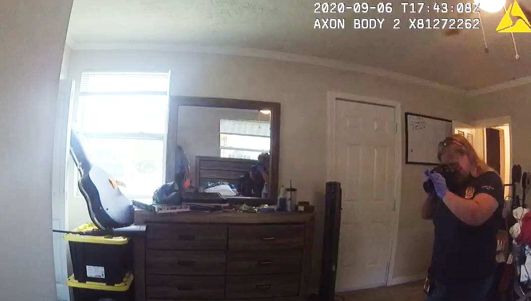 A crime scene investigator taking photos at the home of Alexander Bello-Ortiz shortly after he was fatally injured by a gunshot to the head of Sept 6, 2020.
