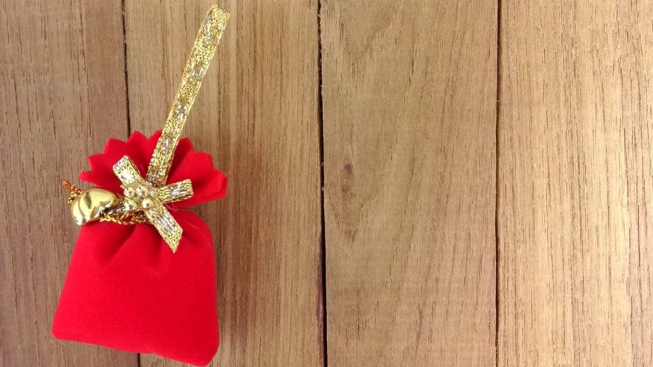 Mete las monedas, el imán, el puñado de azúcar y la canela y laurel todos juntos en una bolsita color rojo, que atarás muy bien para que nada se salga.