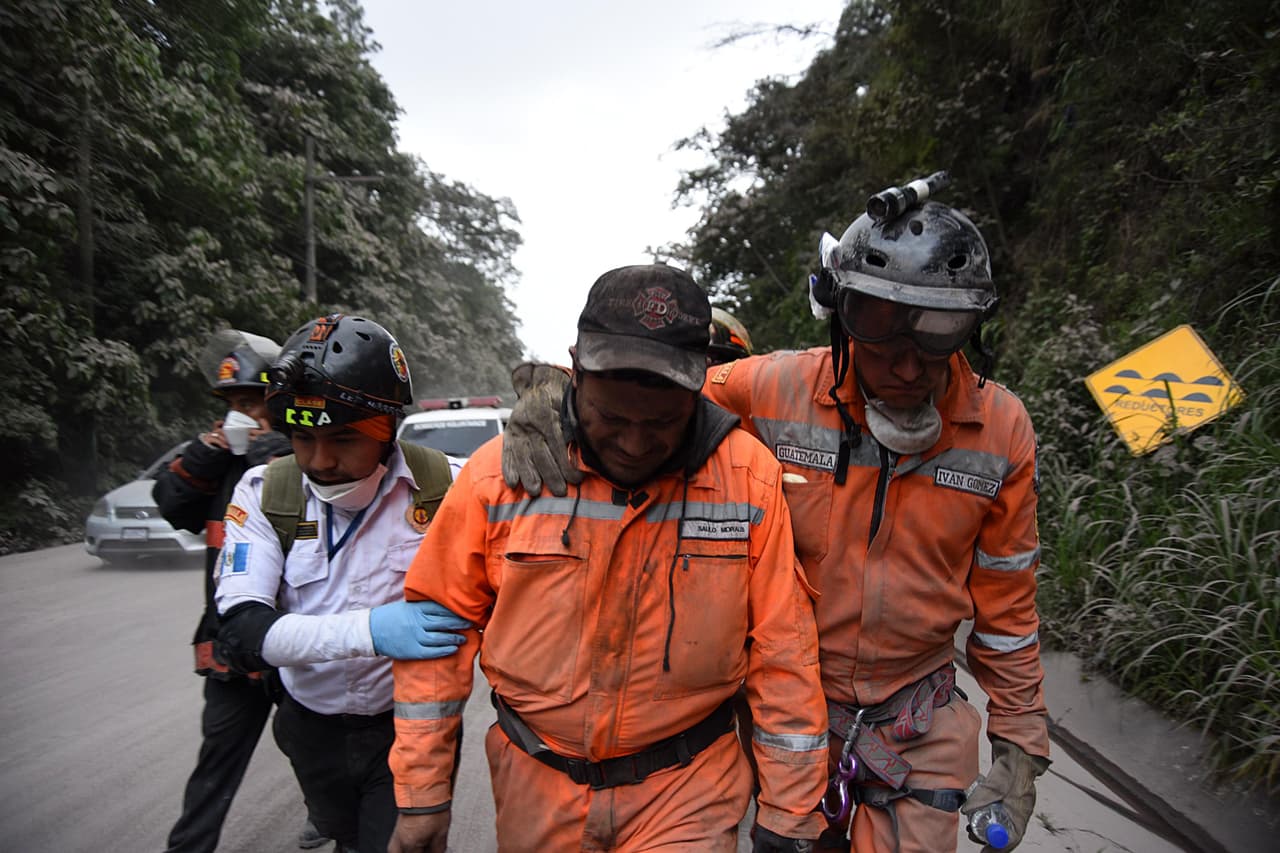 Exhausted rescuers leaving the town of El Rodeo, in the department of Escuintla, about 25 miles from Guatemala City.