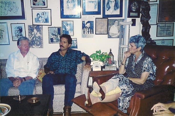 A day after the 1990 election, Daniel Ortega (c) visited Violeta Chamorro (r) at her home to congratulate her after the surprise victory of her UNO coalition over the Sandinista Front. The visit came at the suggestion of former U.S. president Jimmy Carter (l) who accompanied Ortega. Carter is credited with helping persuade Ortega to accept the shock election result.