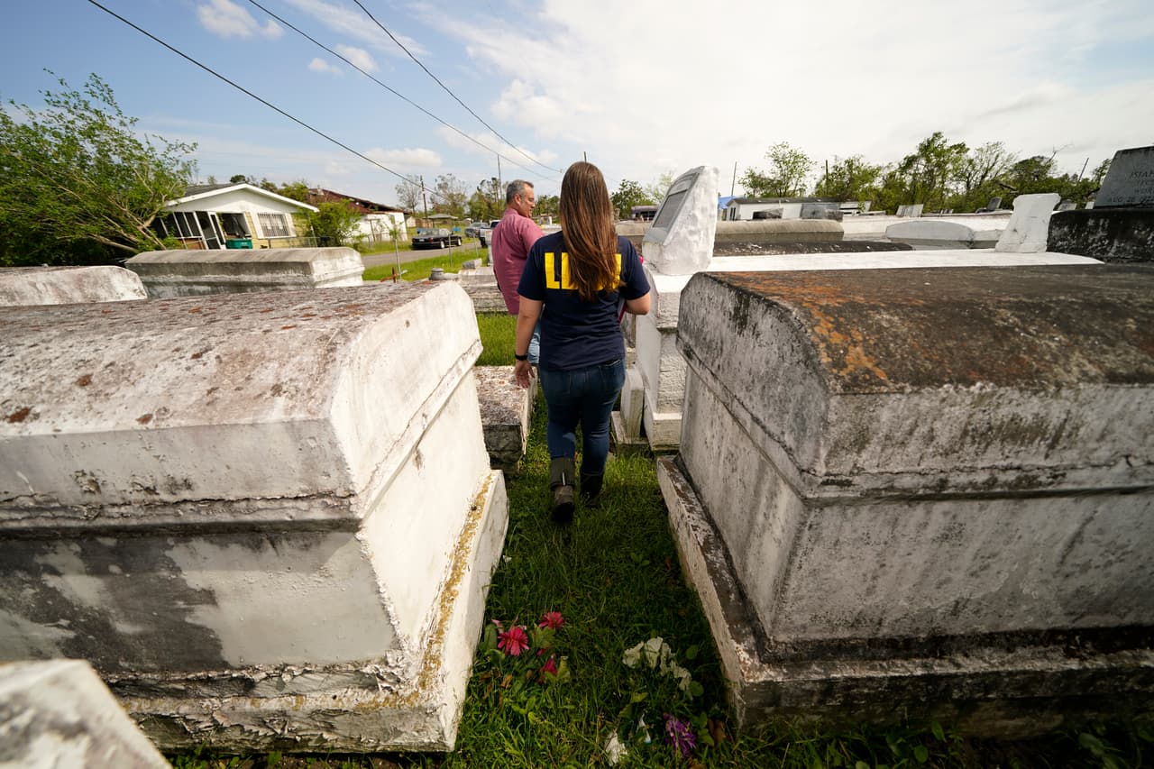 Christine Halling, arqueóloga del Departamento de Justicia de Louisiana, y 
<a href="https://anthro.fsu.edu/alumni/ryan-seidmann" target="_blank">Ryan Seidemann</a>, presidente del Grupo de Trabajo de Respuesta al Cementerio, caminan por un cementerio durante una encuesta en LaPlace, Louisiana.