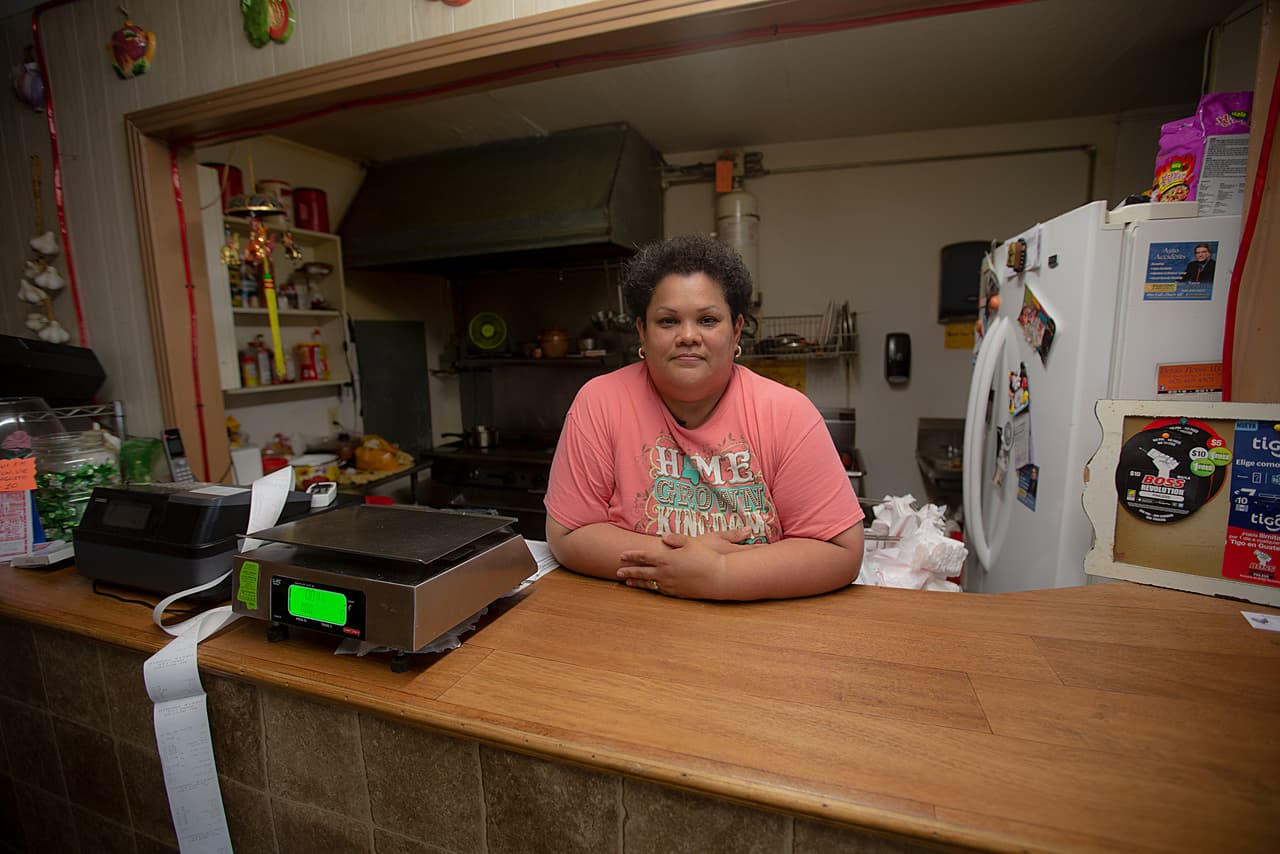 Elena *, at the counter of her store in Morton, Mississippi.