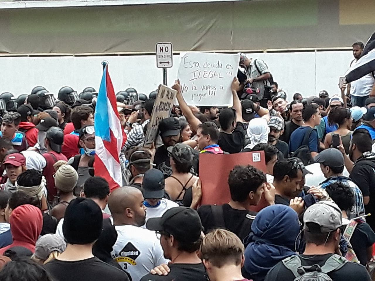 En la foto, los manifestantes se encuentran cara a cara con la policía, que les interrumpió el paso. 
<b>Así permanecieron por unas tres horas pacíficamente.</b> (Foto tomada de la cuenta de Twitter del periodista Manuel E. Rivera)