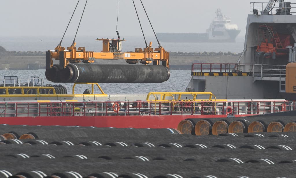 Tubes for the construction of the Nord Stream 2 pipeline are being loaded on a ship at the Mukran port in Sassnitz on the Baltic Sea island of Ruegen, northeastern Germany, on December 12, 2019.