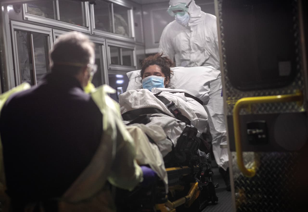 EMS paramedics in PPE bring Zully, a COVID-19 patient, new mother and Guatemalan asylum seeker. (Photo by John Moore/Getty Images)