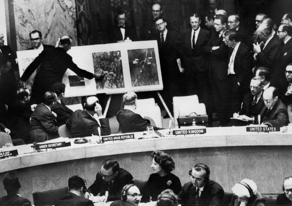 US Administration official shows aerial views of one of the Cuban medium-range missile bases, taken in October 1962, to the members of the United Nations Security Council.