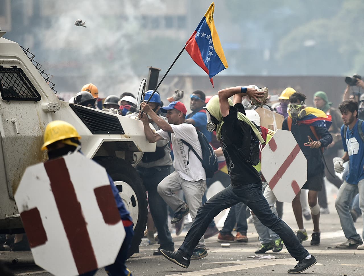 Protesters attack a National Guard armored vehicle.