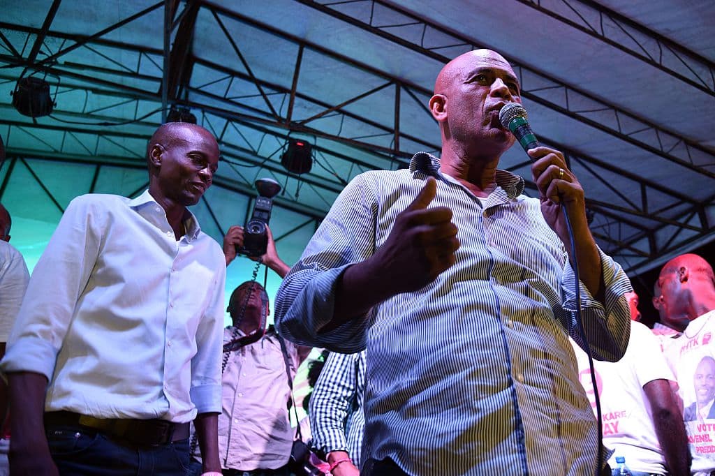 Haitian President Michel Martelly (R) during a rally for the presidential candidate Jovenel Moise (L) of PHTK Party in the commune of Petion Ville, Port-au-Prince, on October 18, 2015. The next presidential elections will be held on October 25.