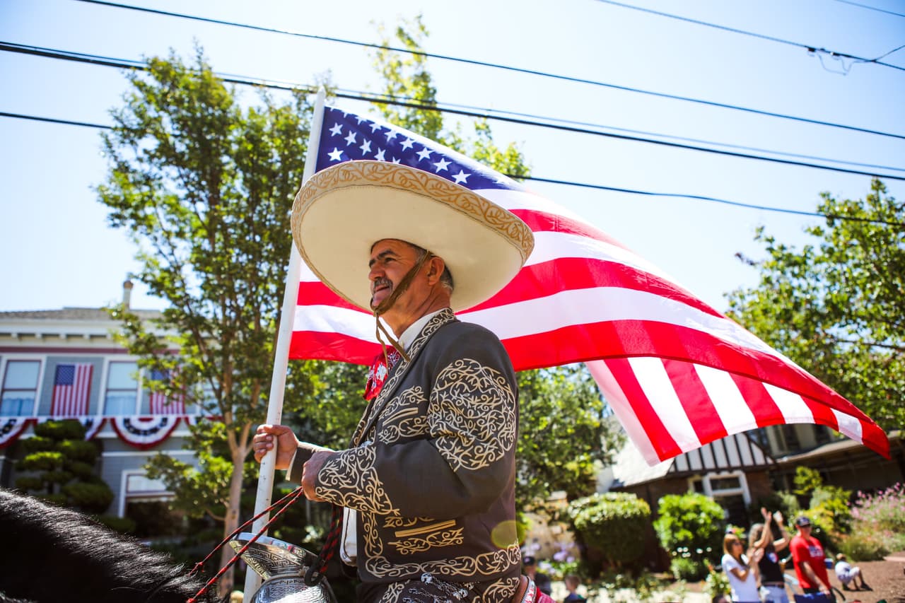 Un charro lleva la bandera de Estados Unidos Alameda, California.