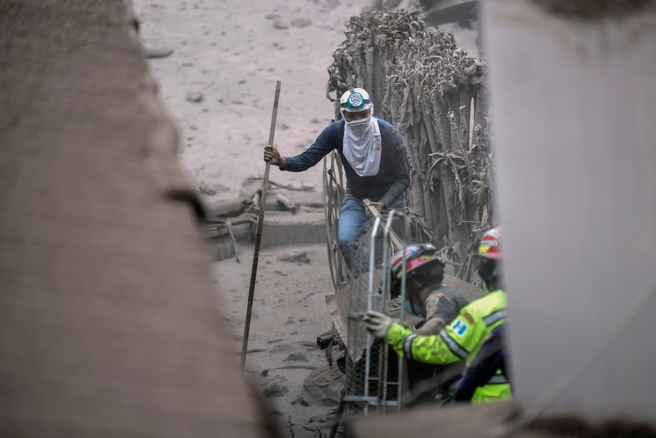 Residents of San Miguel Los Lotes, one of the worst hit communities, try to find survivors after Sunday's eruption of the Fuego volcano.