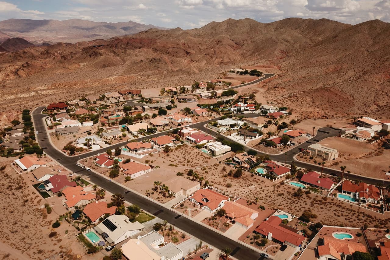 La sequía del oeste se refleja en la represa que alimenta de agua partes de Arizona, Nevada y California. Una imagen aérea muestra casas en Bolder City, derecha, y el lago Mead en el río Colorado, izquierda, cuando se presentan bajos niveles de agua debido a la sequía occidental.