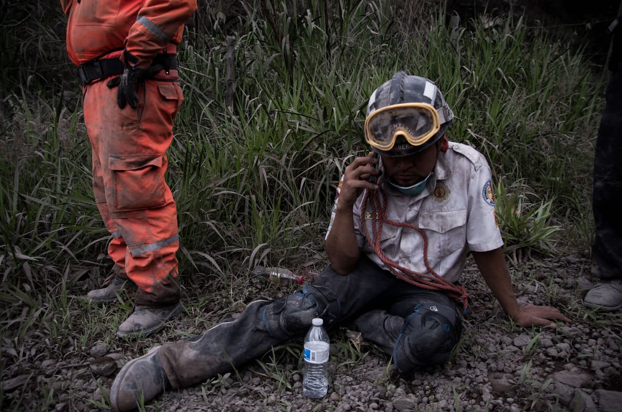 A rescue worker takes a break in the search for survivors.