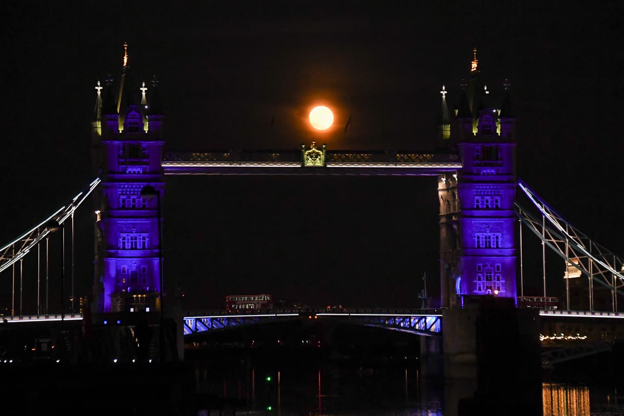 La Superluna se eleva detrás del Tower Bridge de Londres, el jueves 7 de mayo de 2020. La agencia espacial 
<a href="https://solarsystem.nasa.gov/news/1220/the-next-full-moon-is-a-supermoon-flower-moon/" target="_blank">NASA</a> señala además que la Luna llena de mayo se le llama también de leche y de maíz, dependiendo de las diferentes tradiciones.
<br>